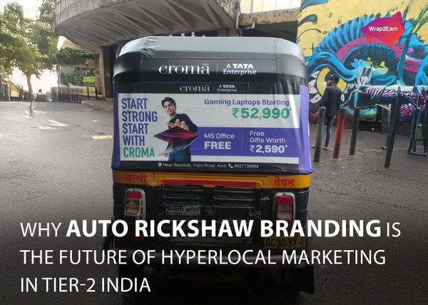 Auto rickshaw wrapped with vibrant ads in a busy city street, powered by Wrap2Earn for hyperlocal marketing