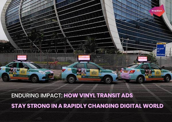  A brightly wrapped taxi and bus on a city street showcasing Wrap2Earn’s transit advertising campaign