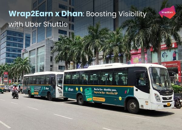 Dhan branding by Wrap2Earn displayed on Uber Shuttle bus advertisements in Delhi.
